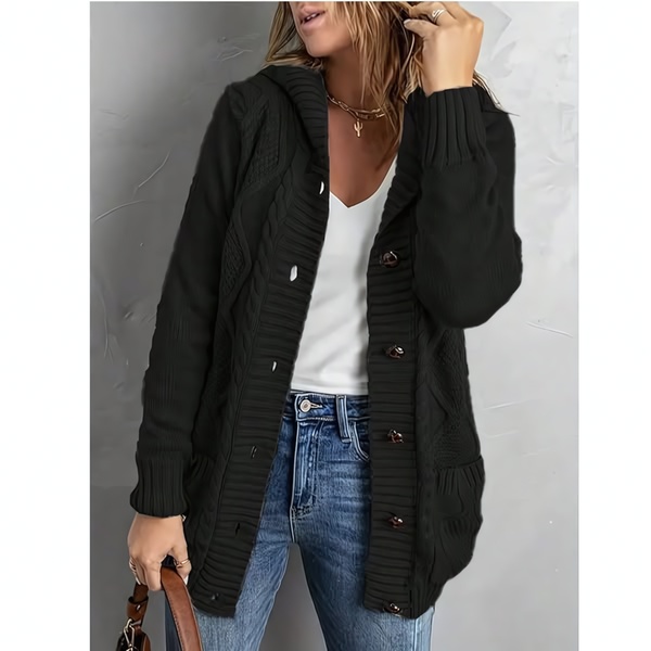 A clean, studio-lit shot featuring a model wearing a black cable knit cardigan against a neutral grey background.