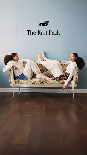 A minimalist, high-end editorial shot featuring two models resting on a vintage floral couch to showcase product versatility.