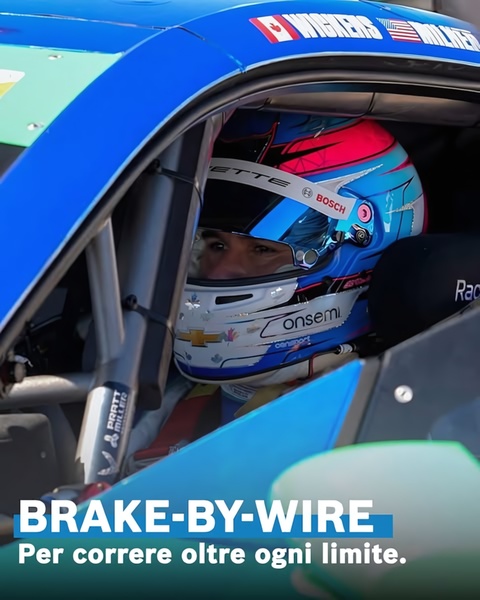 A close-up, first-person view of a driver wearing a professional racing helmet inside a performance car cockpit, emphasizing precision and speed.