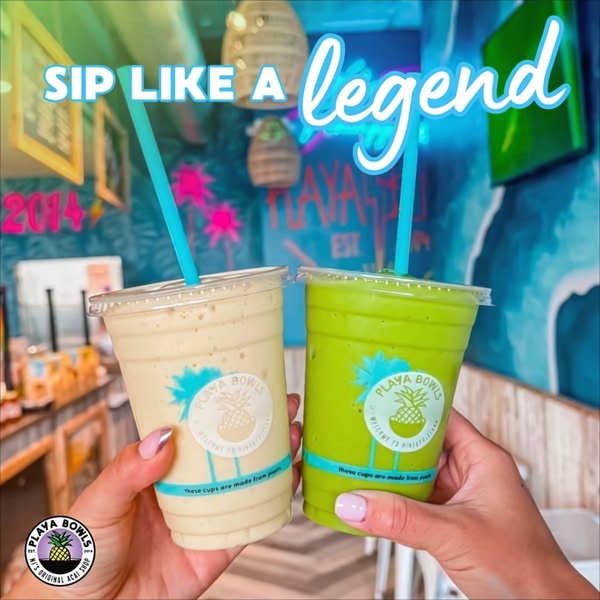A close-up, first-person perspective holding two vibrant drinks in a branded store environment, emphasizing a lifestyle-focused and approachable brand experience.