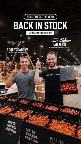 The two founders of Laundry Sauce pose in their warehouse with boxes of Australian Sandalwood detergent, announcing a product restock.
