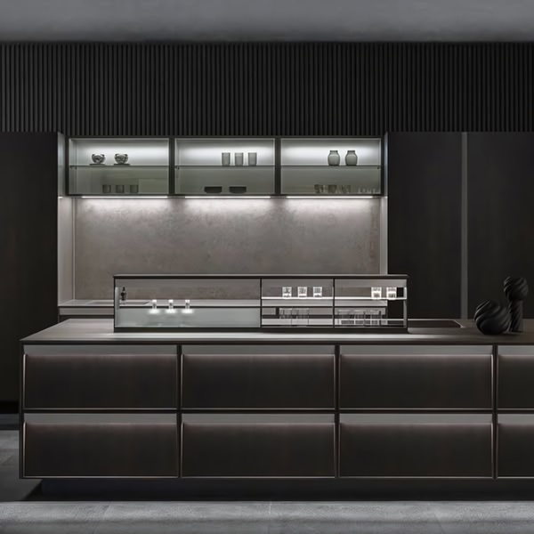 A high-end, dark-themed Kitchen Island display showcasing integrated lighting and premium finishes in a sleek, modern space.