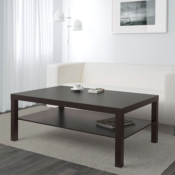 A clean, high-contrast studio shot of a dark brown coffee table featuring a book and a coffee cup, emphasizing a lifestyle-ready aesthetic.