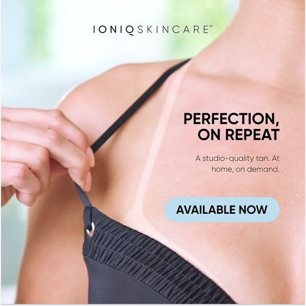A close-up, high-contrast shot of a tan line on a woman's shoulder, highlighting the results of a high-quality home tanning product.