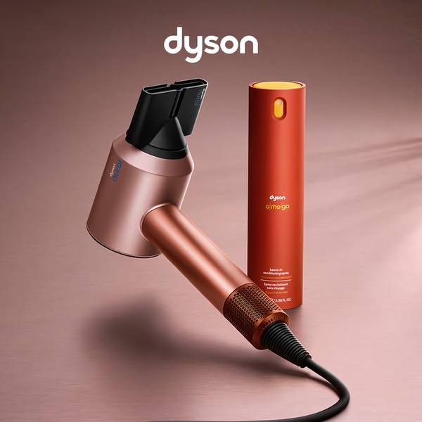 A high-end hair dryer and matching leave-in conditioning spray are displayed against a clean, monochromatic background to emphasize premium quality.