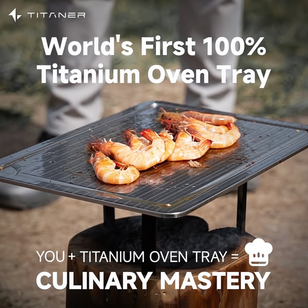 A 1:1 image showing a high-end titanium tray cooking shrimp over an open flame, reinforcing the brand's 'culinary mastery' value proposition.