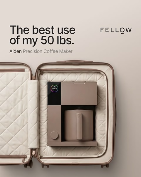 A high-end coffee maker is shown perfectly packed inside a luxury suitcase, highlighting its travel-ready and compact nature.