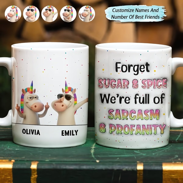A square ad creative featuring two customizable cartoon unicorn characters on a coffee mug with sarcastic, irreverent text for a personalized gift.