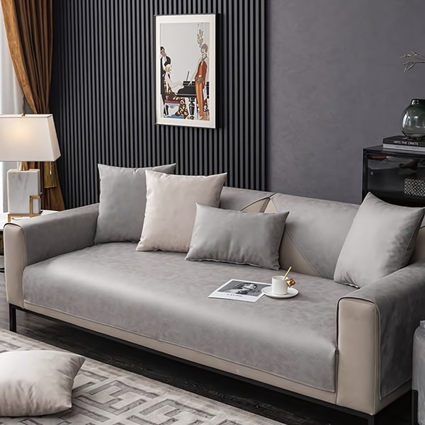 A high-end, neutral-toned sofa cover displayed in a modern living room setting to emphasize quality and home comfort.