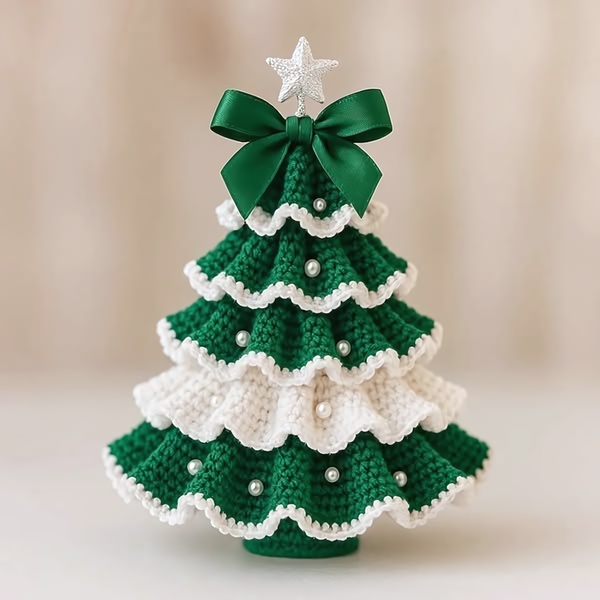 A high-quality, centered shot of a handcrafted crochet Christmas tree with pearl accents and a prominent green ribbon.