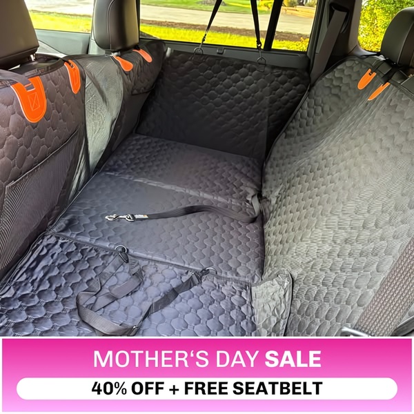 A clean, interior shot of a black quilted car seat cover featuring a high-contrast magenta call-to-action banner for a holiday promotion.