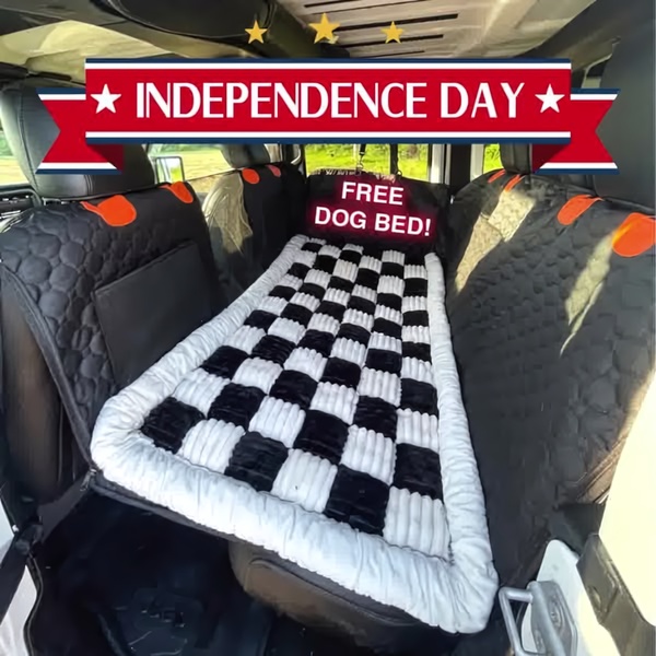A square-format static ad featuring a dog bed set up in a vehicle, promoting an Independence Day sale.