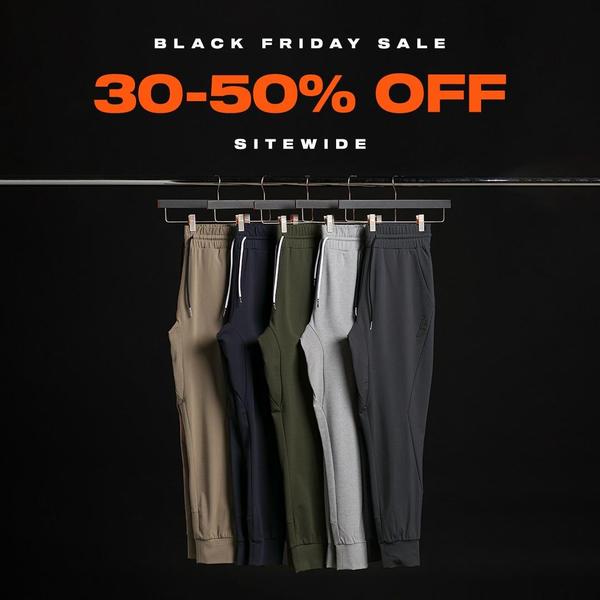 A clean, high-contrast promotional creative featuring multiple colorways of jogger pants hanging on a rack with a bold discount offer.