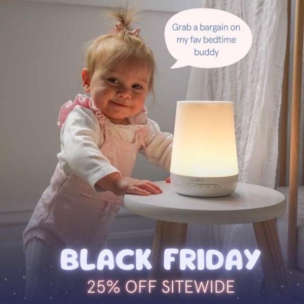 A toddler interacts with a glowing night light on a side table, featuring a speech bubble testimonial and clear Black Friday discount text.