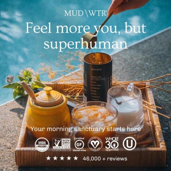 A high-quality lifestyle shot featuring a glass of mushroom coffee on a wooden tray with wellness certification icons and a 46,000+ review social proof highlight.