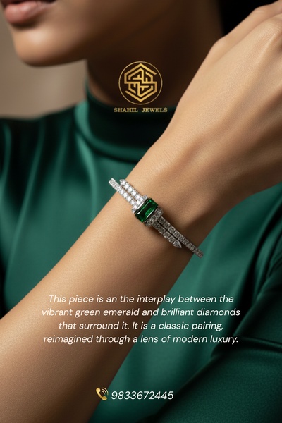 A close-up photograph showcasing a premium emerald and diamond bracelet on a model wearing green, emphasizing sophisticated modern luxury.