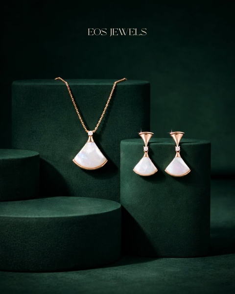 This creative showcases a luxury necklace and matching earring set artfully arranged on dark green cylindrical pedestals to create a sense of premium quality.