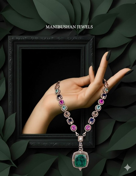 A high-end necklace is displayed on a model's hand emerging from a dark, ornate frame surrounded by deep green leaves.