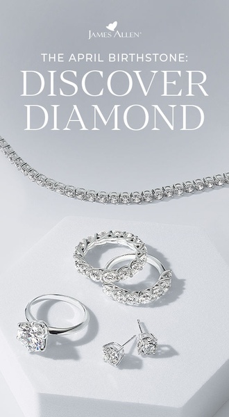 A clean, high-end hero shot showcasing a diamond tennis necklace, engagement ring, stackable rings, and stud earrings on a light gray pedestal.