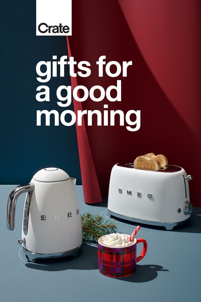 A high-end product hero shot featuring a white kettle and matching toaster, staged with holiday accents to evoke a cozy morning atmosphere.