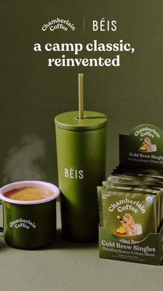 This creative showcases a collaborative product set, featuring coffee singles alongside a branded tumbler in an outdoor-inspired, monochromatic environment.