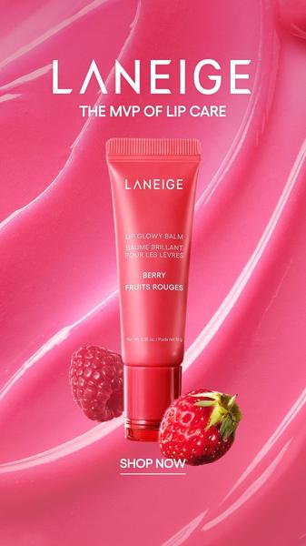 A high-contrast, professional product photograph featuring a single tube of lip balm surrounded by fresh fruit imagery on a textured pink background.
