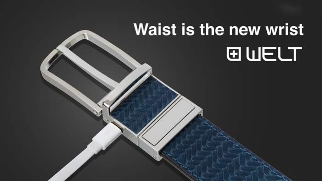 A close-up, high-contrast shot of a smart belt featuring a charging cable plugged into the buckle, emphasizing the fusion of fashion and technology.