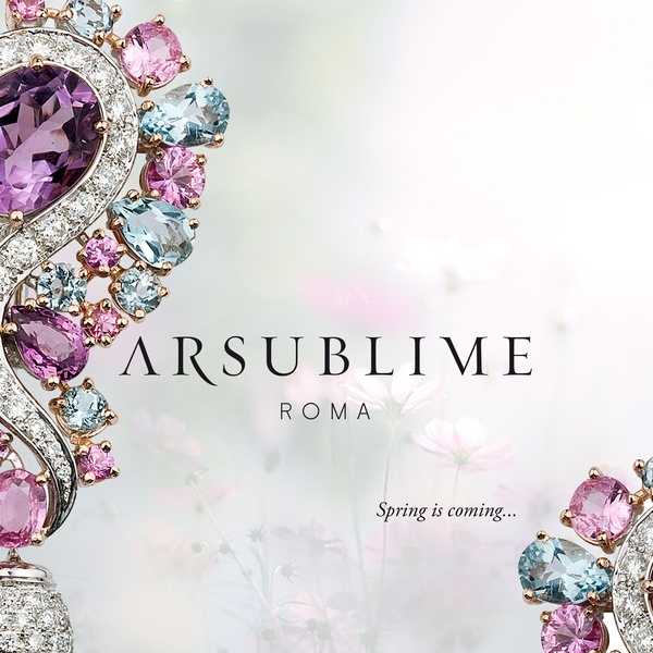 A high-end, minimalist display of a luxury jewelry set featuring amethyst and topaz stones against a soft floral background.