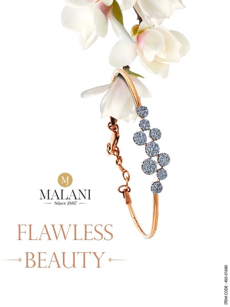 A high-end jewelry advertisement featuring a gold bracelet adorned with floral elements, emphasizing a clean and luxurious brand aesthetic.