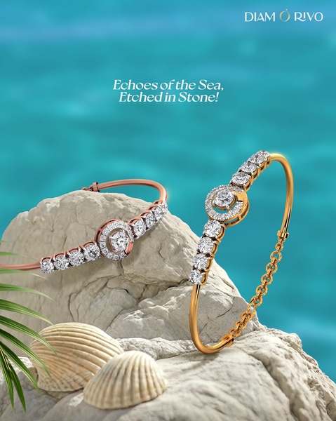 Two elegant diamond bracelets are placed on sun-bleached rocks against a vibrant turquoise ocean backdrop.