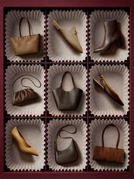 A high-end product display featuring various handbags and shoes organized in a grid, mimicking a premium chocolate box presentation.