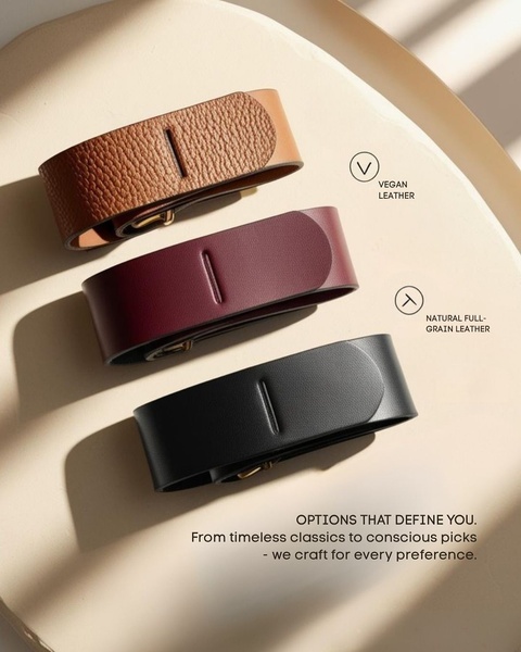 A clean, studio-lit display of three leather belts in different finishes, using simple line-art indicators to highlight material quality and variety.