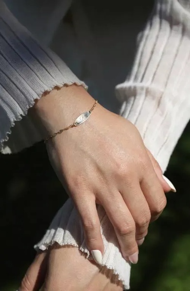 A close-up lifestyle shot featuring a delicate gold bracelet on a wrist, emphasizing elegance and subtle sophistication.