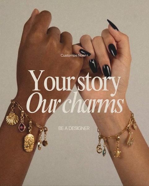 A close-up, high-fashion lifestyle shot featuring two hands wearing personalized charm bracelets, emphasizing personal storytelling and customization.