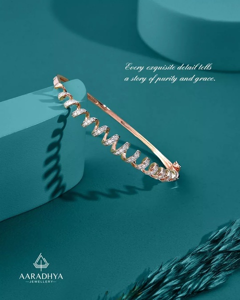 A close-up, high-end product shot of a spiral diamond bangle displayed on a teal geometric surface, emphasizing luxury and design detail.