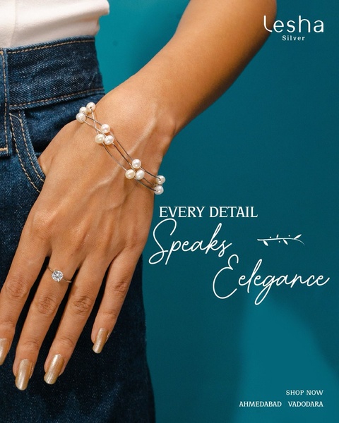A close-up product hero shot featuring a delicate pearl bracelet and a diamond ring on a model's wrist against a solid teal background.