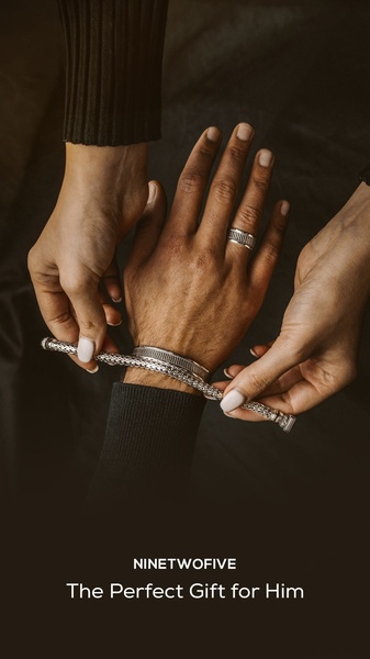 A close-up view showing hands carefully presenting a silver bracelet and ring, highlighting a premium gift-giving experience.