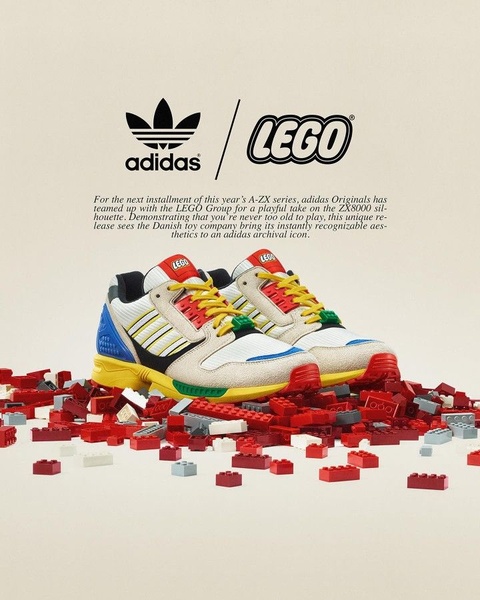 A high-quality product hero shot featuring a branded running shoe sitting atop a scattered pile of colorful building blocks against a neutral studio background.