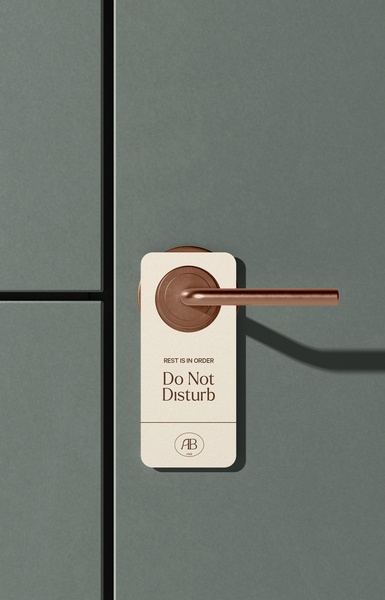 A high-end door hanger visual featuring a copper-toned handle and a clean, neutral-toned hanger design focused on brand identity.