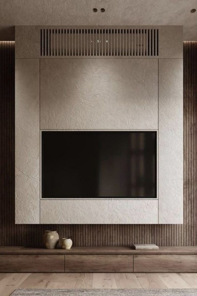 A high-end interior design shot focusing on a wall-mounted TV integrated into a textured, neutral-toned feature wall.