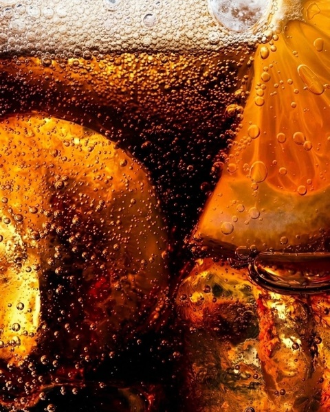 A high-fidelity, macro-style close-up shot capturing a refreshing iced cola drink with visible condensation, carbonation bubbles, and fresh orange slices.