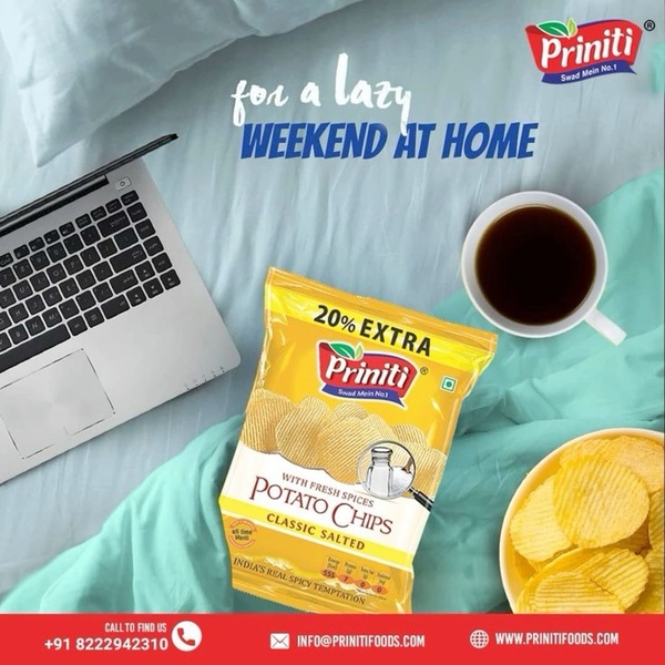 This ad creative uses a high-angle lifestyle shot featuring a bag of potato chips next to a laptop and coffee, evoking a relaxed weekend at home.