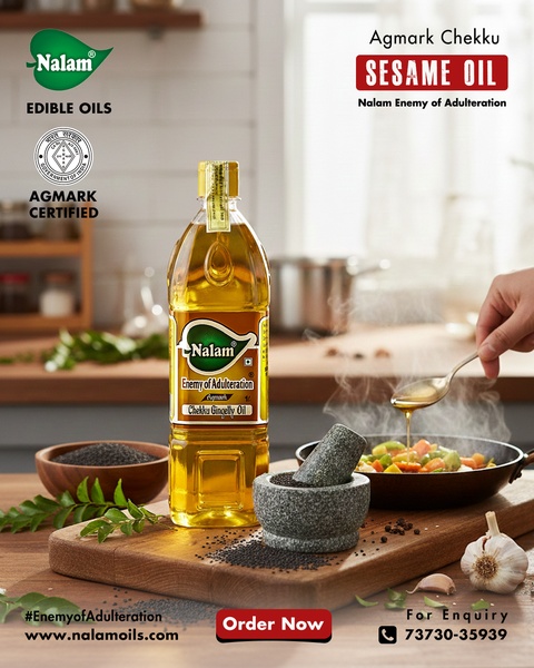 A high-quality product shot of Nalam Sesame Oil placed in a clean, professional kitchen setting with fresh ingredients to imply purity and freshness.