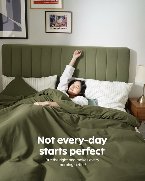 A high-quality lifestyle image of a woman stretching in an upholstered bed with a minimalist green palette, emphasizing comfort and the start of a day.