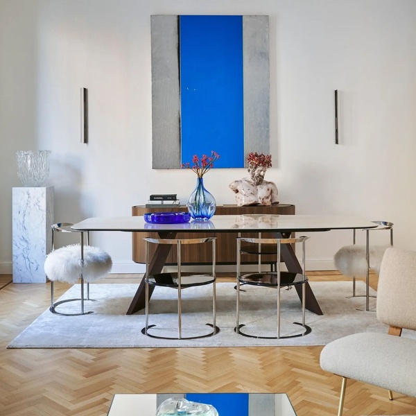 A high-end, editorial-style photograph featuring a modern dining table in a bright, professionally styled room, emphasizing a sophisticated aesthetic.