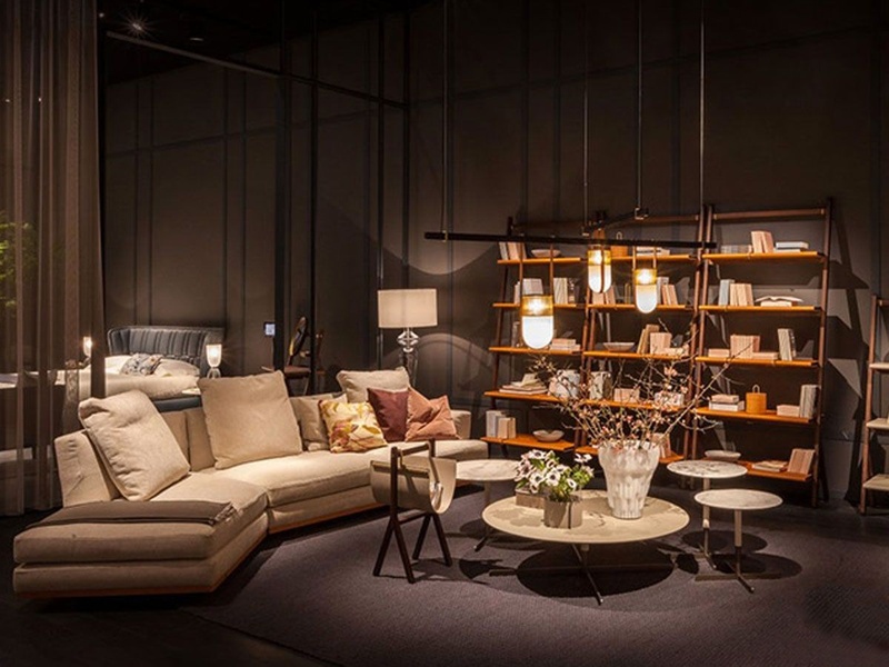 This ad creative displays a high-end sectional sofa within a dark, moody, and upscale residential setting to establish premium brand value.