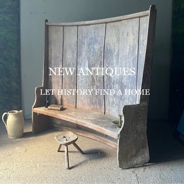 A refined, high-contrast hero shot of a weathered wooden bench that uses simple text overlays to evoke a sense of timelessness.