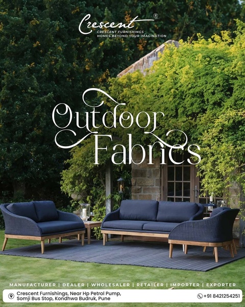A high-quality lifestyle shot featuring elegant outdoor furniture arranged in a lush garden setting to showcase premium fabric durability.