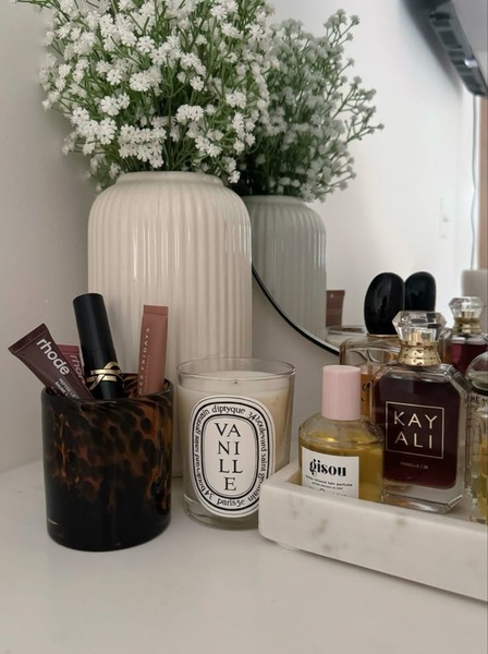 perfume bottles, scented candles, lip balm, lipstick, beauty vanity, skincare products, brand awareness, lifestyle, minimalist, calm, luxurious, neutral