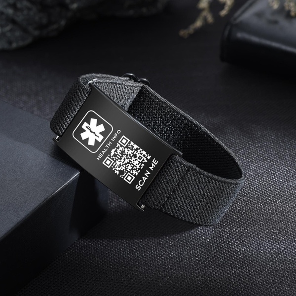 A high-contrast, professional product shot of a black medical alert bracelet featuring a prominent QR code for instant health info access.